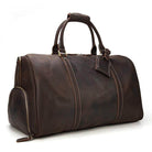 Genuine leather weekender bag in dark brown with sturdy handles and a spacious design for travel