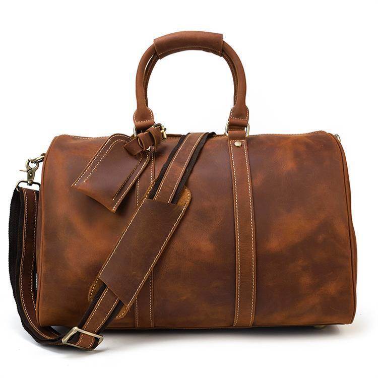 Genuine leather weekender bag in rich brown color with dual handles and adjustable shoulder strap