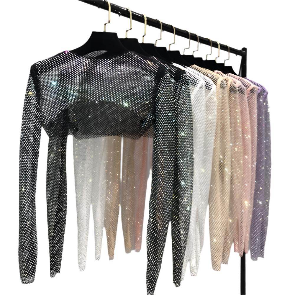 Variety of Women's Clubwear featuring glitter crop tops in multiple colors hanging on a rack