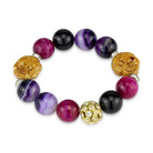 Colorful gold rhodium brass bracelet with beads including purple and pink tones and decorative skull accents