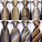 Collection of men's ties featuring a gold paisley formal tie among elegant designs and patterns