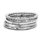 Stack of high polished silver bracelets for women featuring various textures and styles