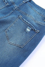 Close-up of VacationGrabs high rise flare jeans showcasing distressed back pocket design
