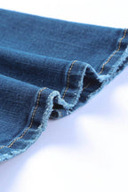 Close-up of the hem detailing on VacationGrabs high rise flare jeans in blue denim fabric
