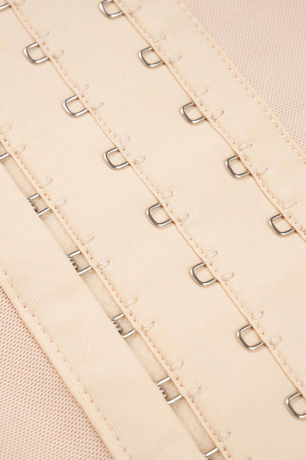 Close-up of lace trim bodysuit for women featuring hook-and-eye closures for a secure fit