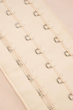 Close-up of lace trim bodysuit for women featuring hook-and-eye closures for a secure fit