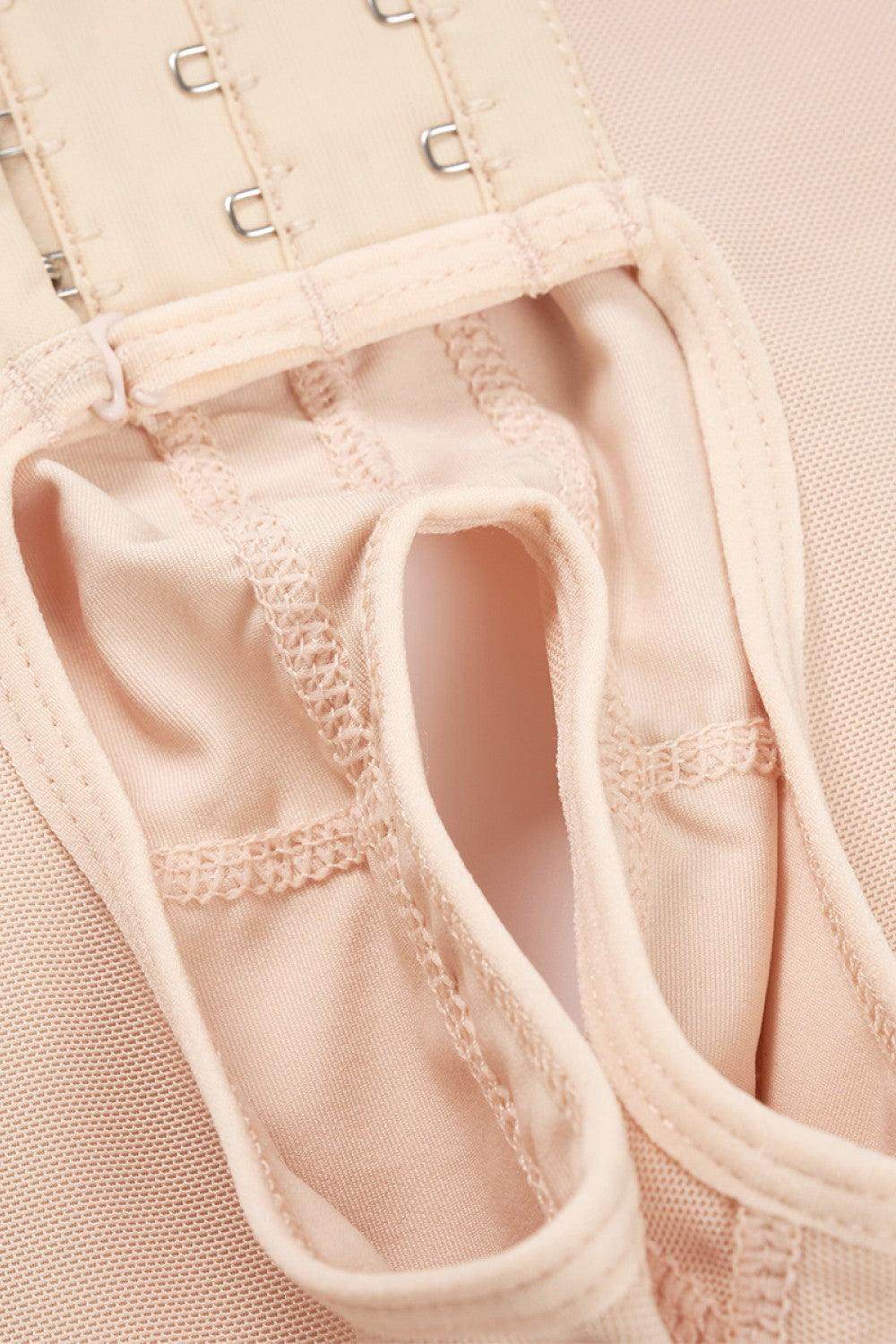 Close-up of Trendsi lace trim bodysuit for women showcasing hook closures and soft fabric details