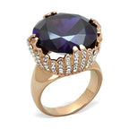 Large gemstone cocktail ring with an oval purple stone and sparkling accent stones in a gold-tone setting