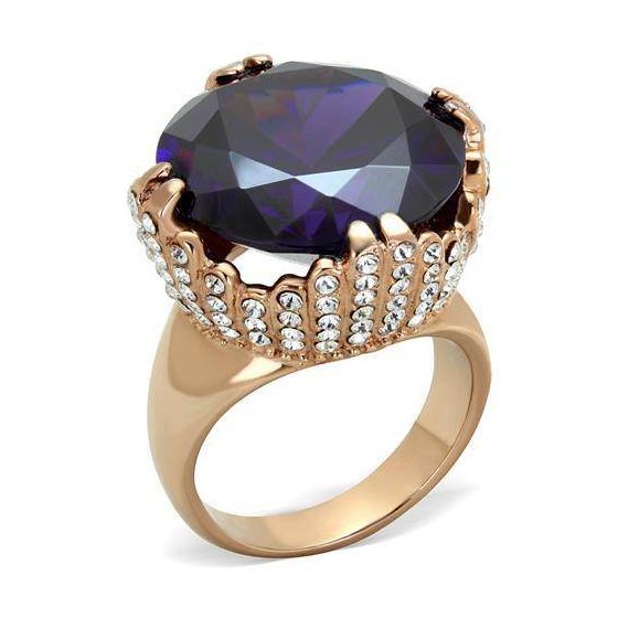 Large gemstone cocktail ring with an oval purple stone and sparkling accent stones in a gold-tone setting