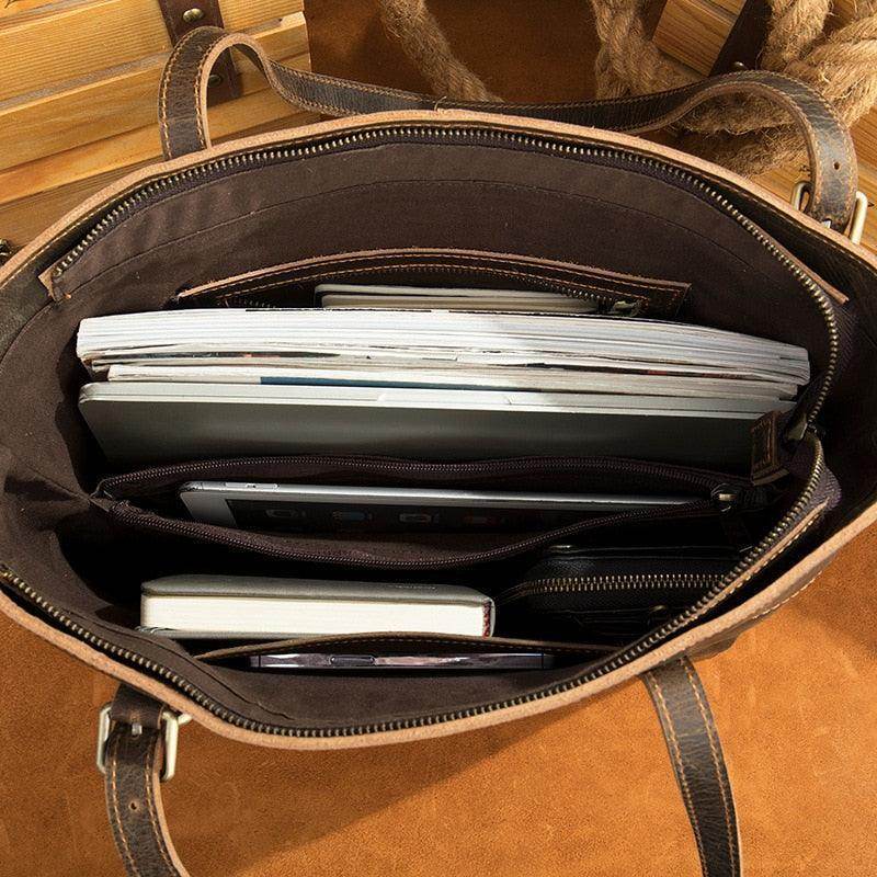 Interior view of a leather messenger bag for travel with multiple compartments for organization