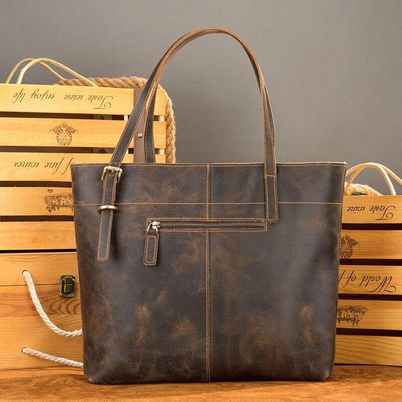 Brown leather messenger bag for travel with adjustable straps and multiple pockets for organization
