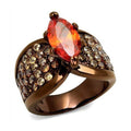 Light brown gemstone statement ring with vibrant orange center and sparkling accents