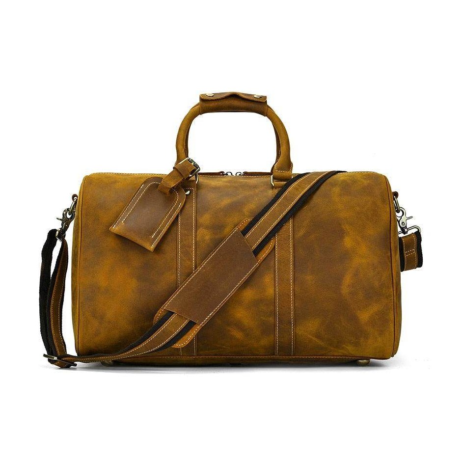 Luxury business travel bag in distressed brown leather with adjustable shoulder strap and sturdy handles