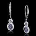 Luxury vacation jewelry for women, featuring elegant silver earrings with sparkling purple gemstones