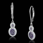 Luxury vacation jewelry for women, featuring elegant silver earrings with sparkling purple gemstones