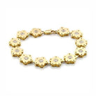 Matte gold flower bracelet for women featuring floral charms and sparkling center stones
