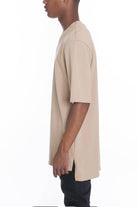 Men's casual vacation top in beige featuring a relaxed fit and side slits for comfort