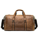 Mens large travel duffel in brown leather with sturdy handles and adjustable strap for versatile use