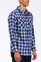 Men's plaid flannel shirt in blue and brown tones with two front pockets and long sleeves