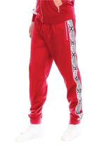 Mens red track pants with a stylish snake print side design for a trendy athletic look