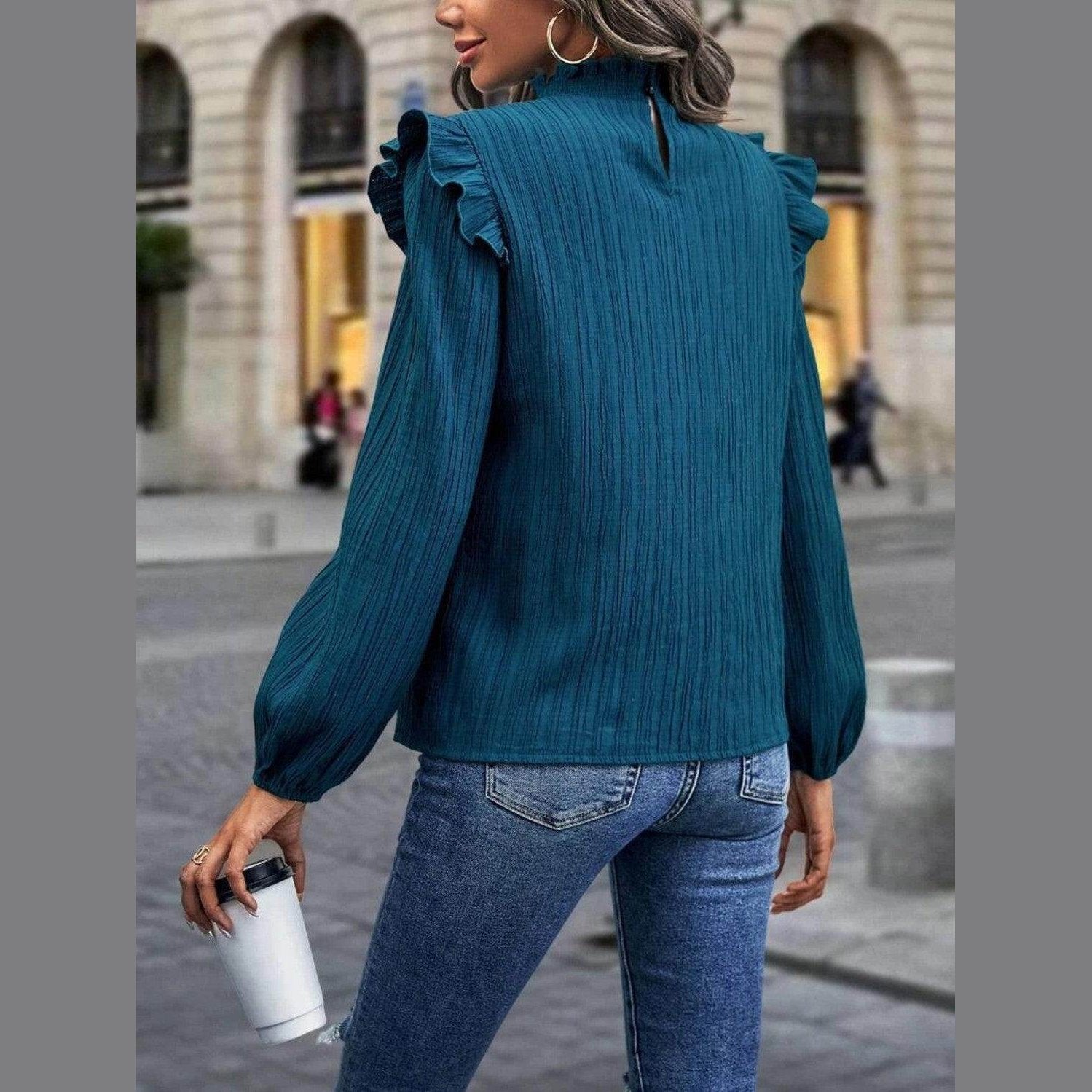 Women's teal mock neck blouse for travel with ruffle sleeves and a stylish back slit