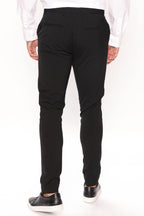 Back view of modern slim fit trousers black from Fashion Nova featuring a tailored design for a sleek look