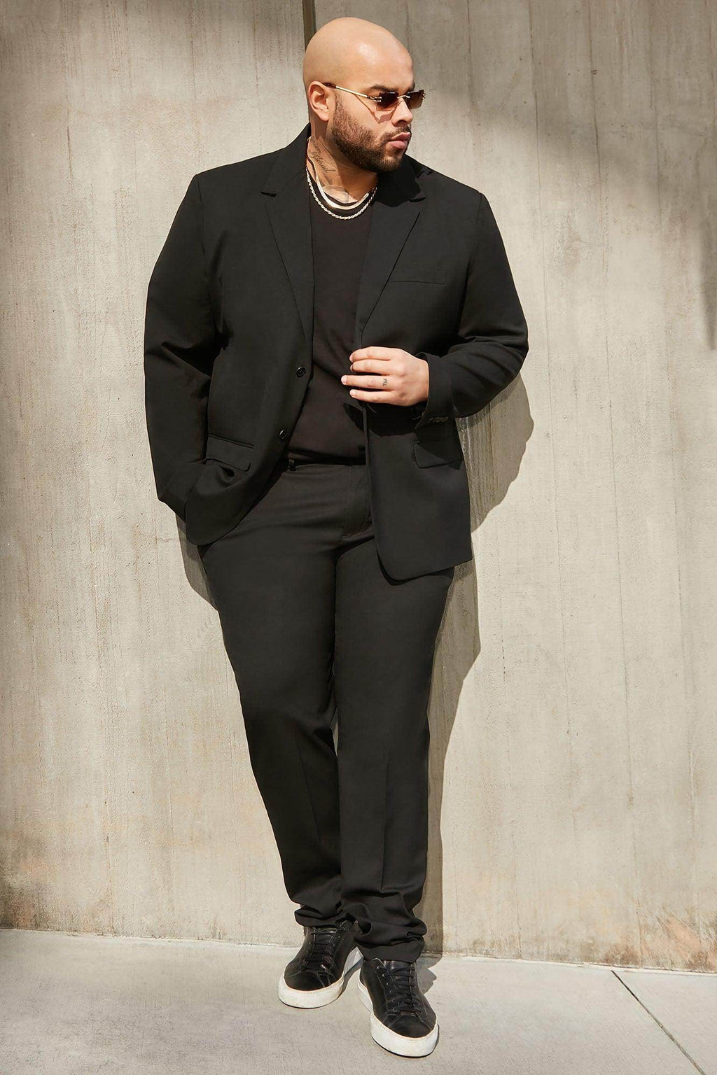 Fashion Nova modern suit jacket for men in black paired with stylish pants and sneakers