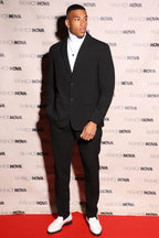 Fashion Nova modern suit jacket for men in black worn with a white turtleneck and stylish shoes