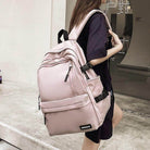 Stylish pink nylon backpack for travel with multiple compartments and ergonomic design for comfort.