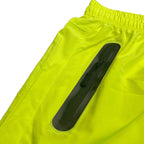 Close-up of VacationGrabs neon yellow running shorts featuring a secure zip pocket