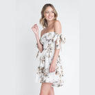 Ivory Felix off shoulder floral romper with smocked bodice and tie sleeves for a trendy summer look
