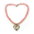 Pink beaded heart pendant necklace featuring gold accents and a sparkling centerpiece