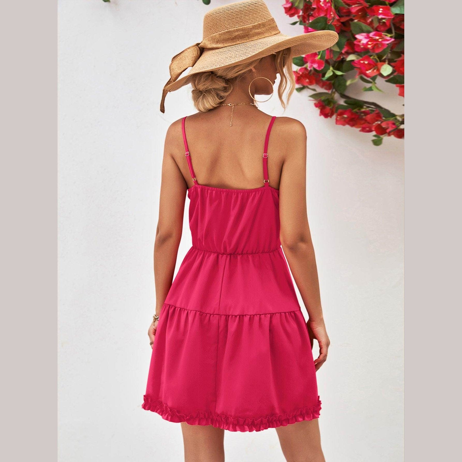 Stylish back view of a pink frill dress for vacation, featuring a tiered design and adjustable straps