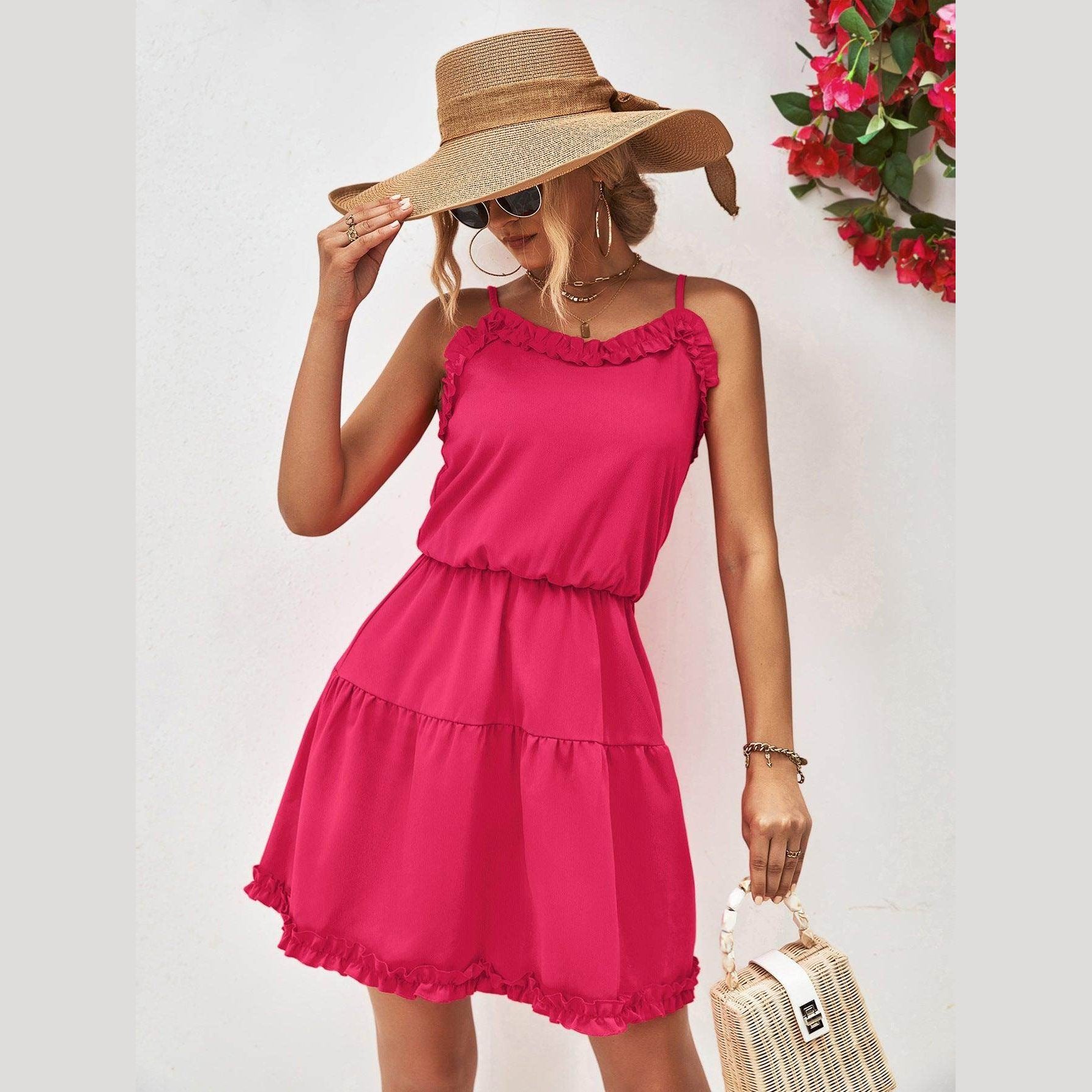 Trendy pink frill dress for vacation with adjustable straps and ruffled hem, perfect for sunny days