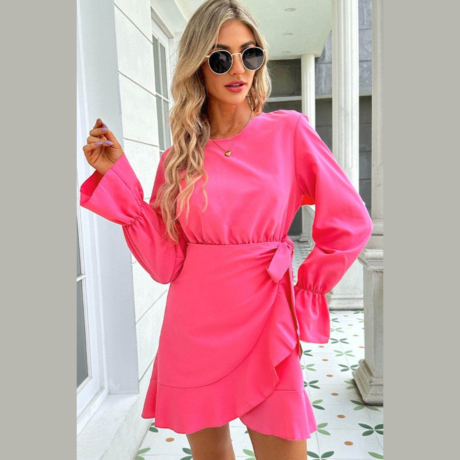 Trendsi Pink Vacation Dress featuring long sleeves and a stylish wrap design