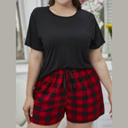 Plus size lounge set featuring a black top and red plaid shorts for comfortable sleepwear