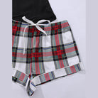 Trendsi plus size scoop neck pajamas featuring a black top and plaid shorts for comfortable lounging