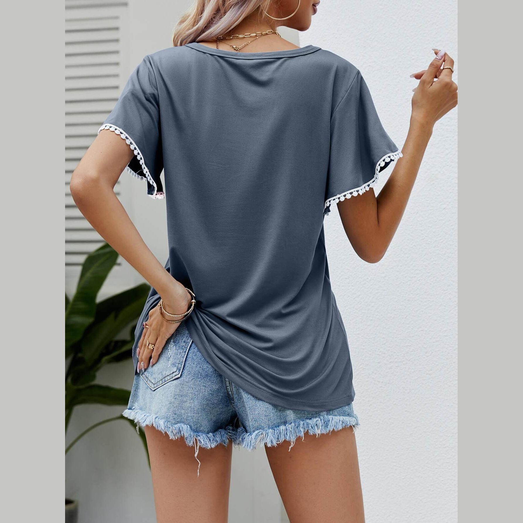 Trendsi women's pom-pom flutter sleeve tee in grey styled with distressed denim shorts