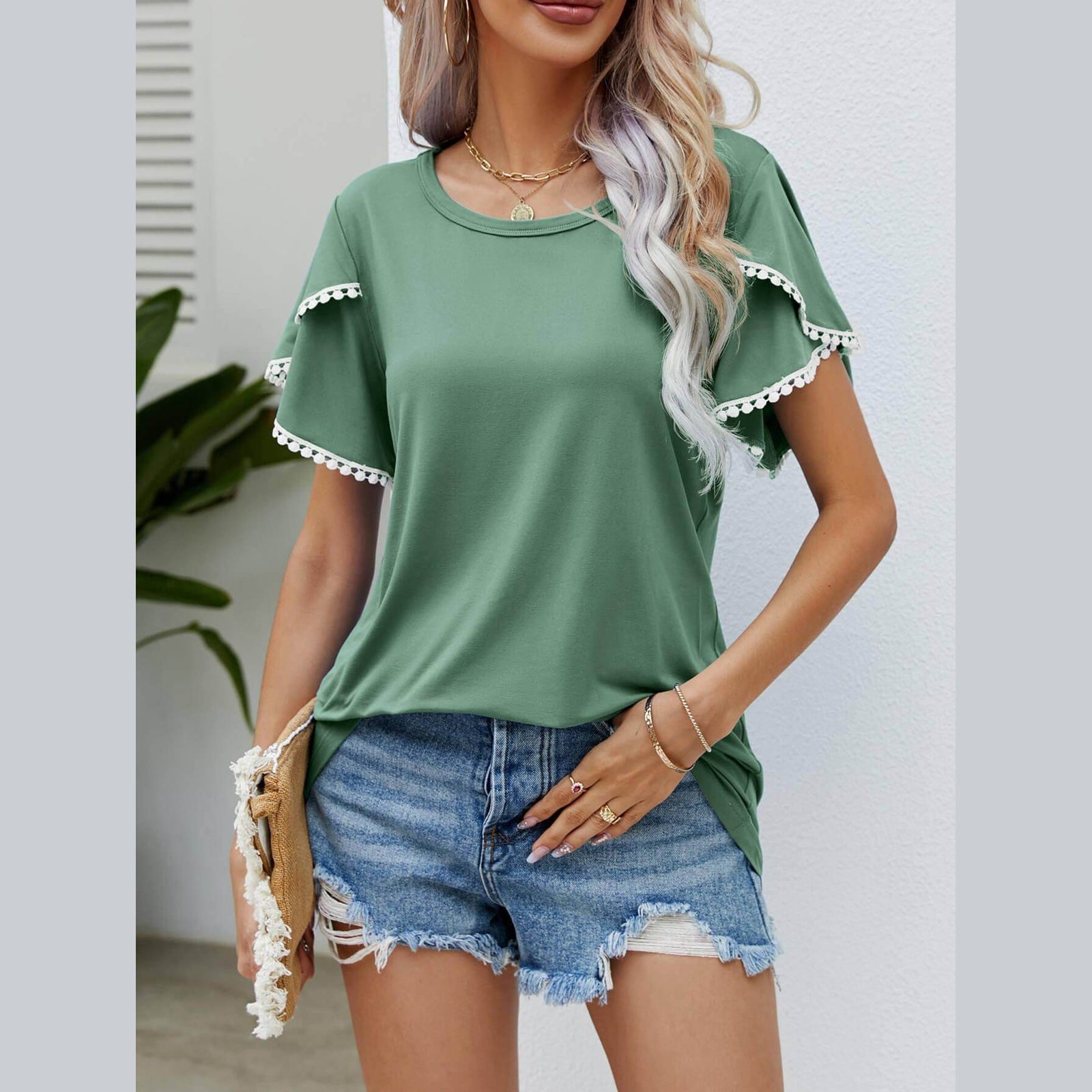 Trendsi women's pom-pom flutter sleeve tee in green paired with denim shorts for a casual summer look