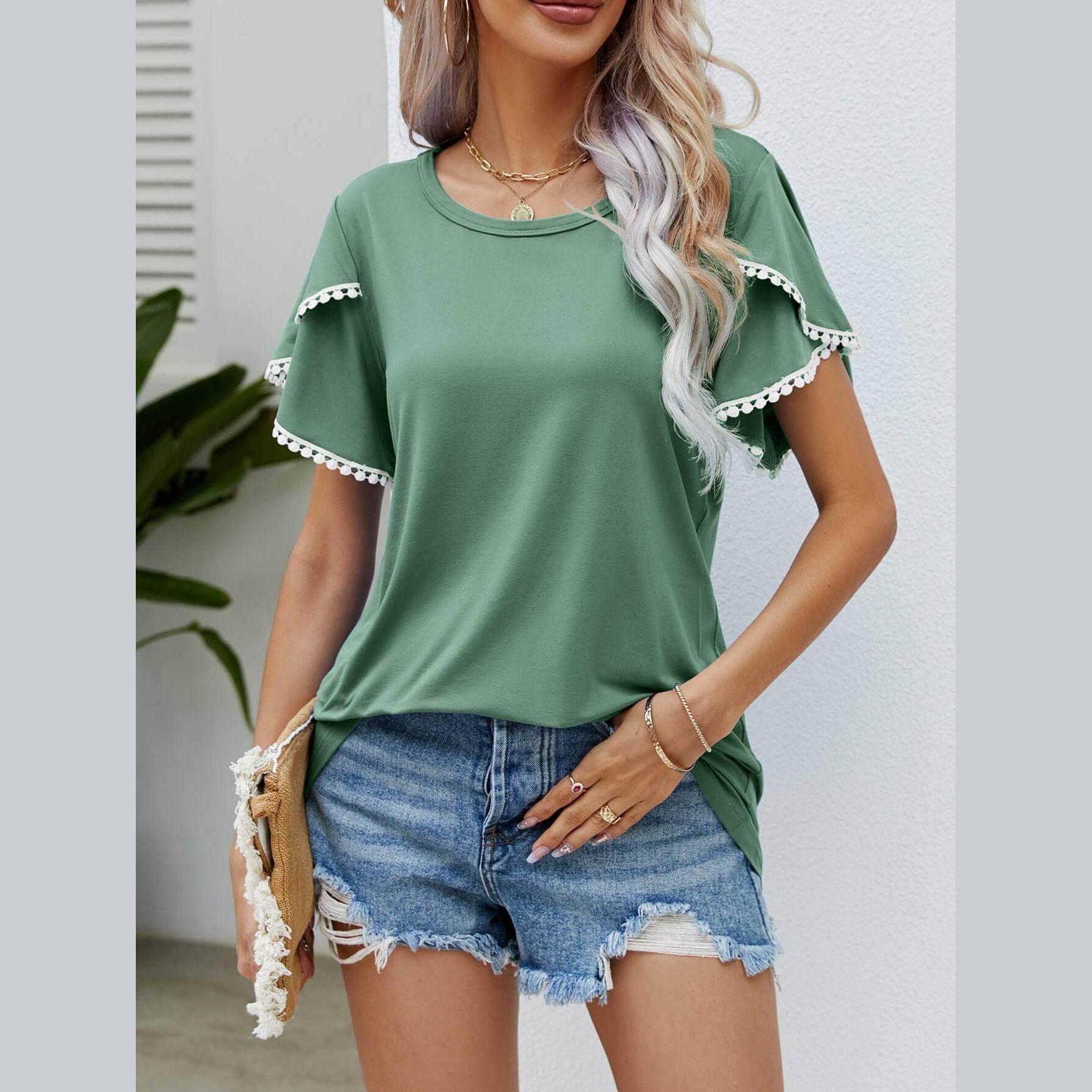 Trendsi women's pom-pom flutter sleeve tee in green paired with denim shorts for a casual summer look