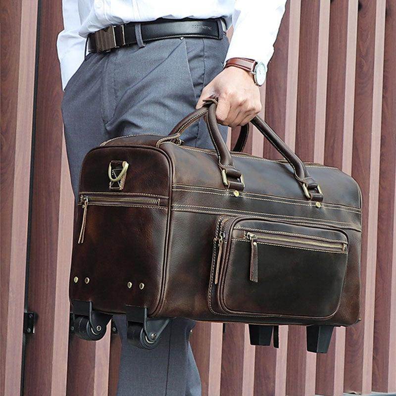 Premium leather wheeled duffel bag in dark brown with sturdy handles and zippered pockets
