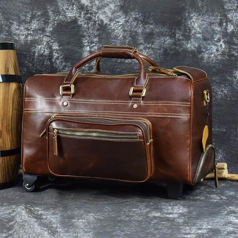 Premium leather wheeled duffel bag in brown with sturdy handles and zipper pockets