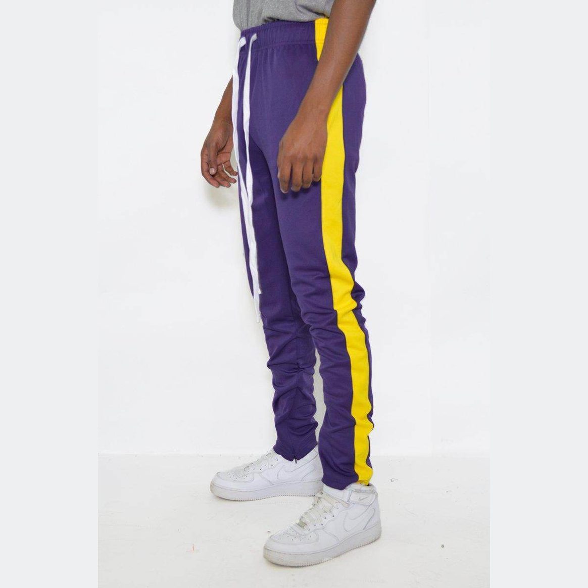 Men's purple yellow track pants from VacationGrabs with a stylish side stripe design