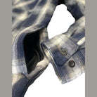 Close-up of VacationGrabs quilted flannel shirt showing button detail and fabric texture