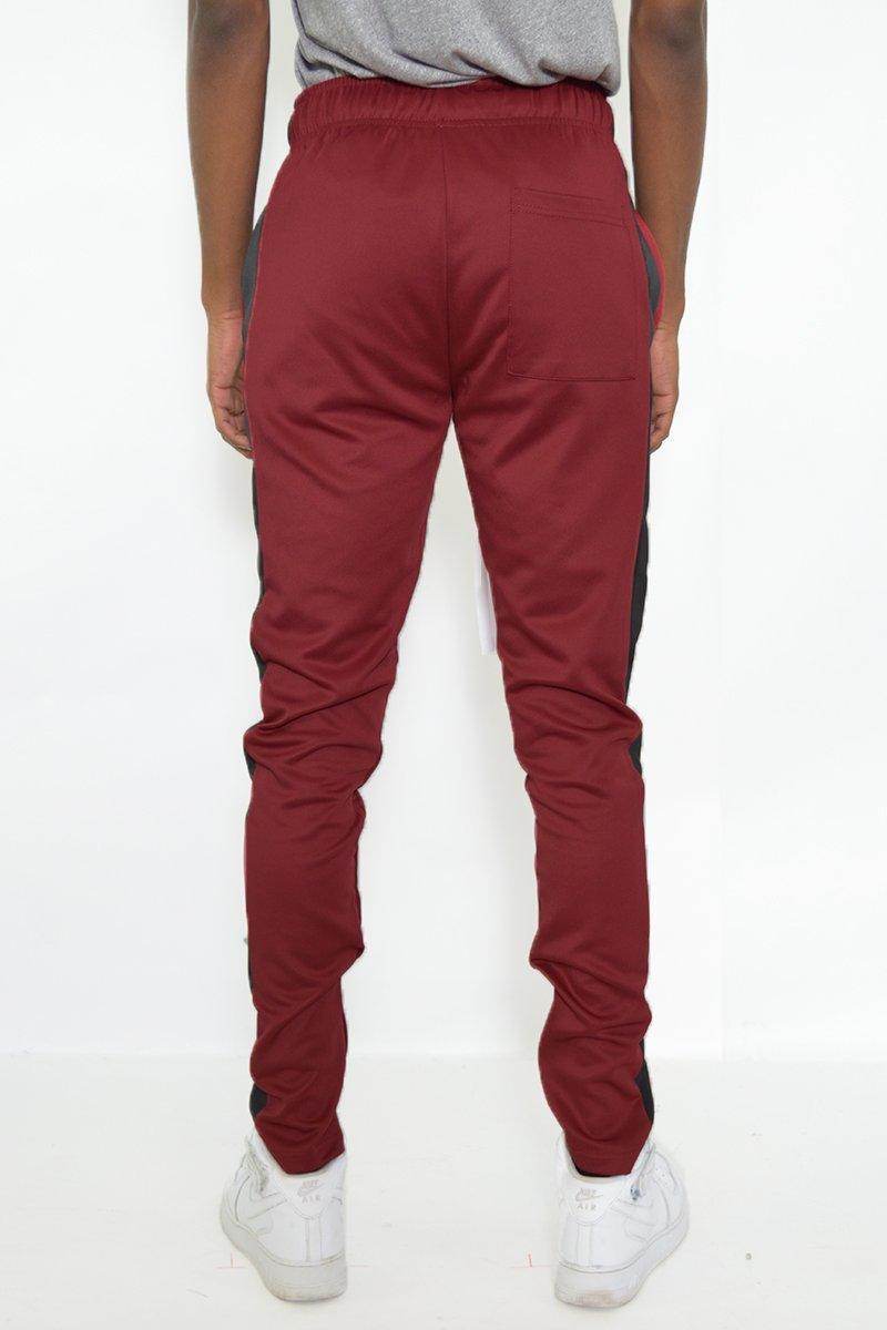 Back view of red black jogger pants for men with elastic waistband and tapered fit