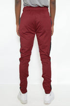Back view of red black jogger pants for men with elastic waistband and tapered fit
