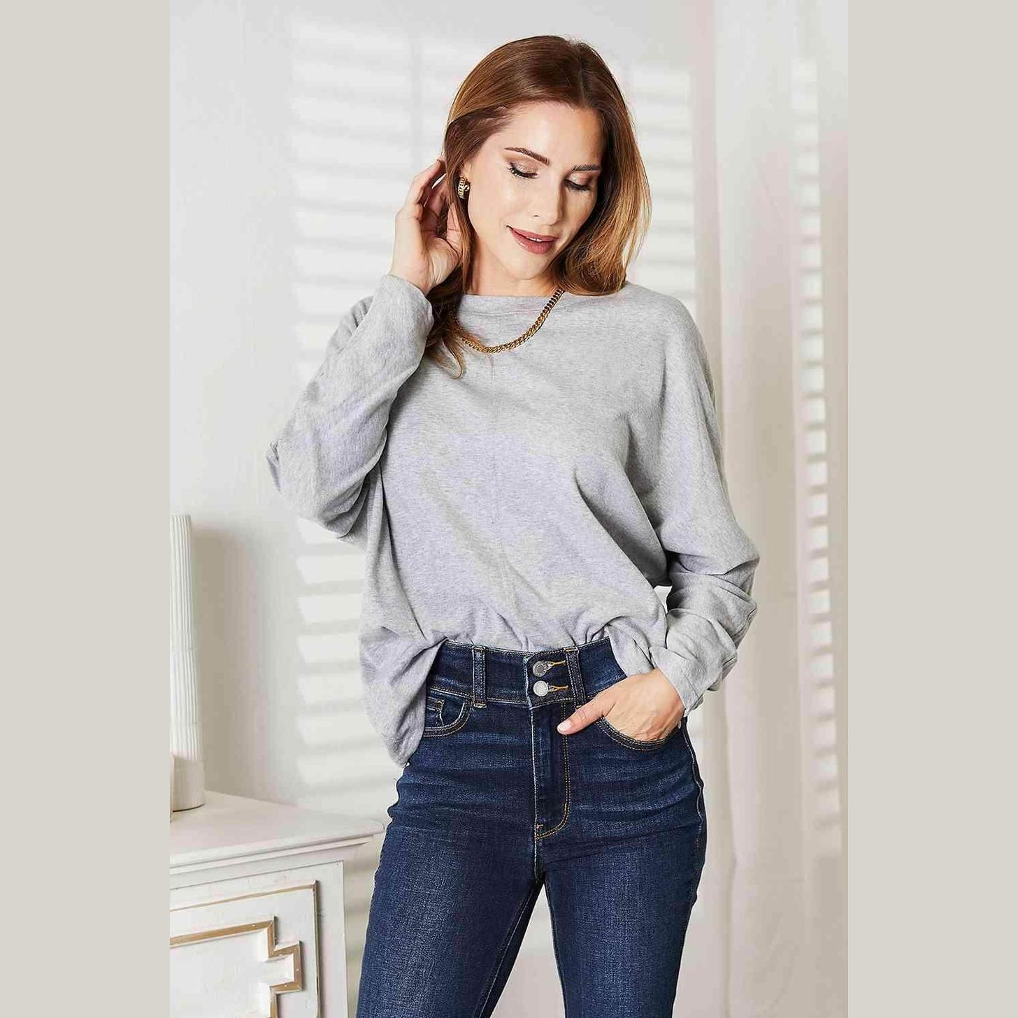 Trendsi round neck long sleeve top in gray paired with high-waisted jeans for a chic look