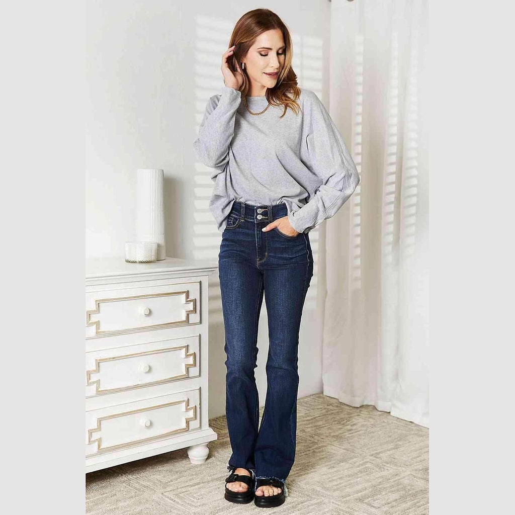 Trendsi Women's Round Neck Long Sleeve Top in Gray, paired with flared jeans for a stylish casual look