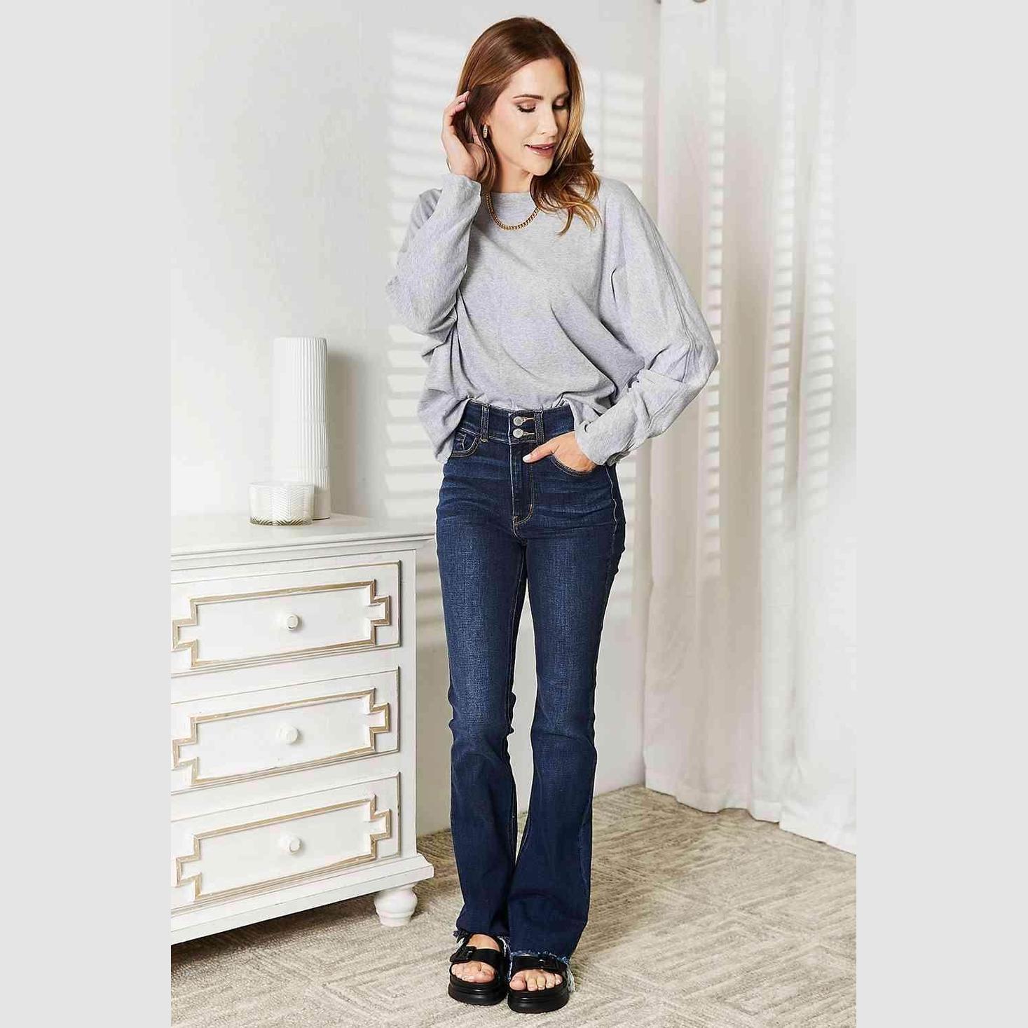 Trendsi Women's Round Neck Long Sleeve Top in Gray, paired with flared jeans for a stylish casual look