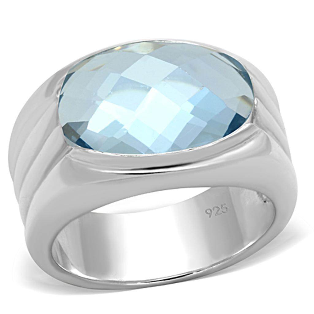 Silver cocktail ring for women featuring a large blue gemstone and sleek band design